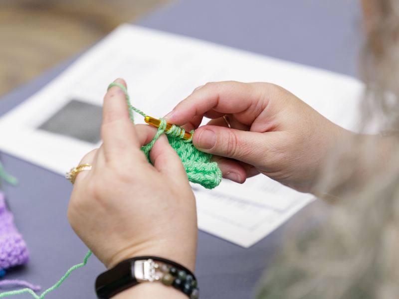 A maker being shown how to use a machine in a hands-on class
