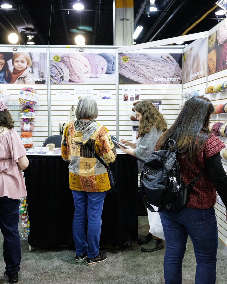 Festival-goers browsing an exhibitor display