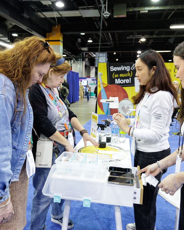 Attendees at a hands-on maker activity table